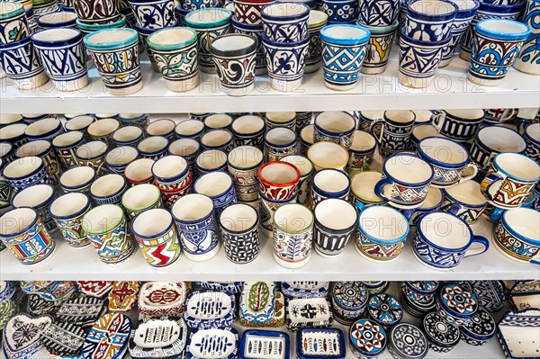 Shelves full of handmade ceramic products in pottery factory in Fez