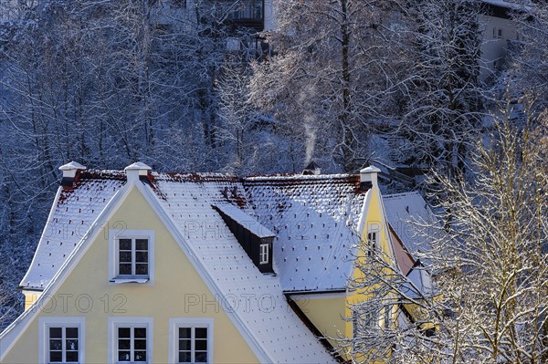 Snow-covered house roof with dormer window