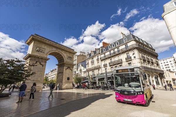 Bus in front of the triumphal arch Porte Guillaume at Place Darcy