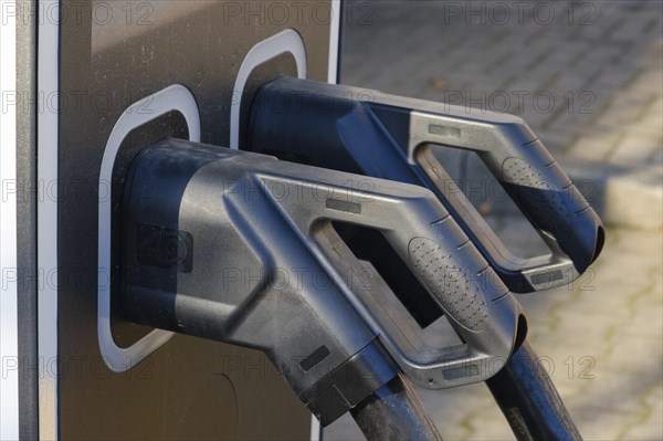 Electric charging cable at a petrol pump for electric cars