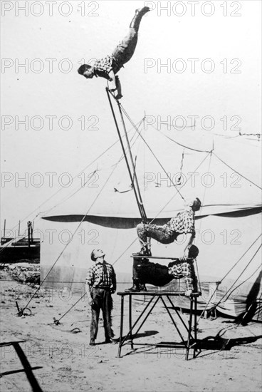 Old archival black and white photograph from the 1920s showing acrobats