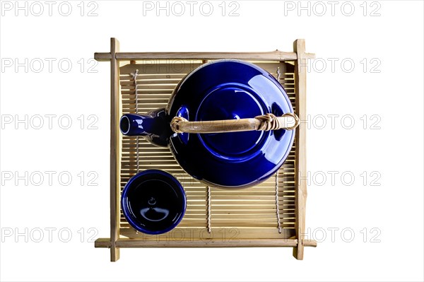 Teapot and cup on bamboo tray