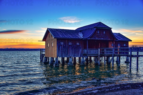 Boathouse at the Lake Ammer at sunset in winter