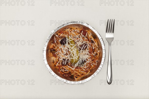 Fork and aluminium plate with noodles
