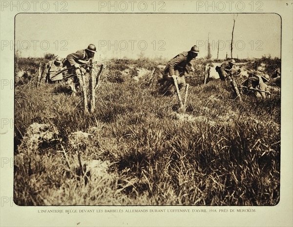 Infantry soldiers charging Germans and crossing barbwire obstacles at the battlefield at Merkem in Flanders during WWI