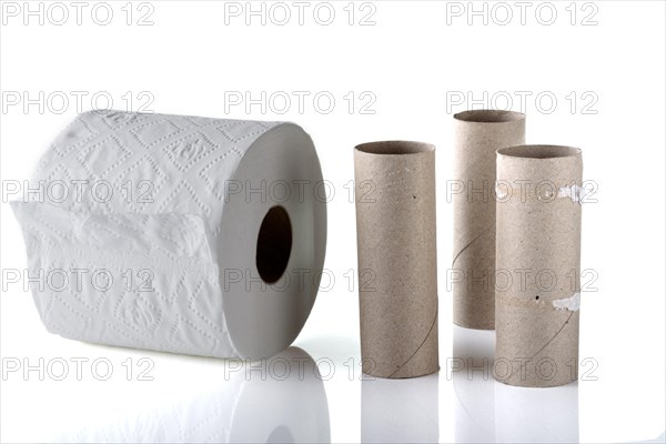 Three empty toilet rolls alongside a new full roll