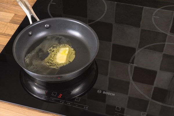 Butter melting in a frying pan