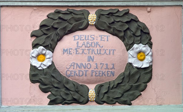 Ornament and inscription on an old dwelling house in Jever from 1711