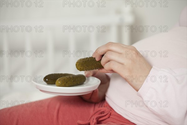 Pregnant woman with pickles on baby belly | MR:yes NH_pregnant_belly_mr