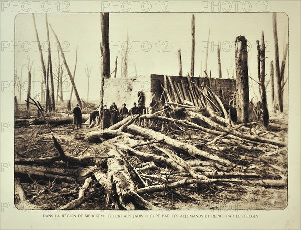 Soldiers standing next to bunker in bombarded forest at Merkem in Flanders during the First World War