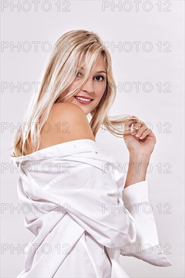 Portrait of a woman sitting in front of a white background