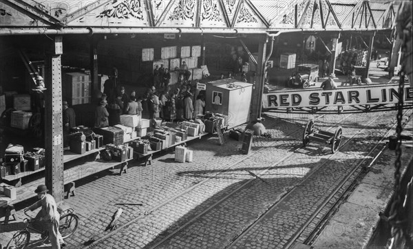 Old early 1900s photo of European emigrants travelling to the United States boarding steamship of the Red Star Line in the port of Antwerp