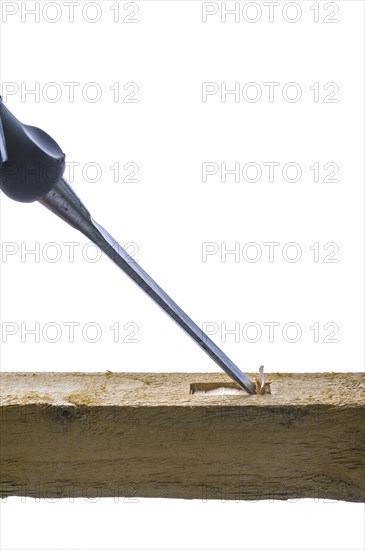 Chisel cutting a mortise into some sawn timber