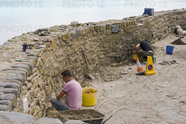 Workmen maintaining the harbour