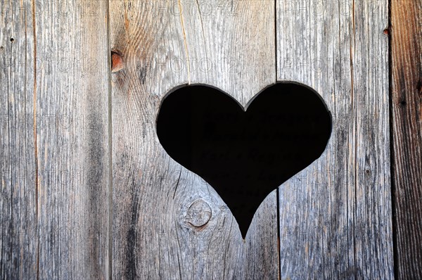 Heart in the door of a toilet house