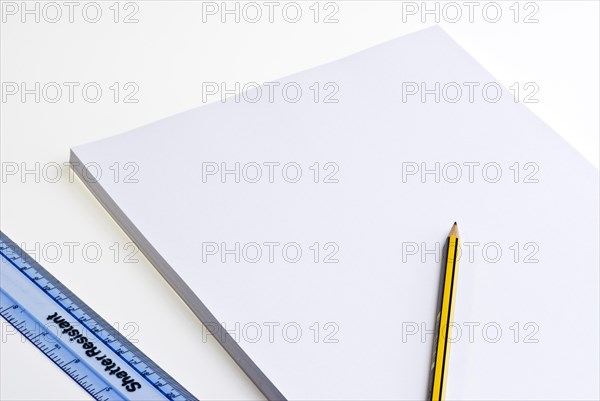 Blank pad of white paper with a pencil and plastic ruler