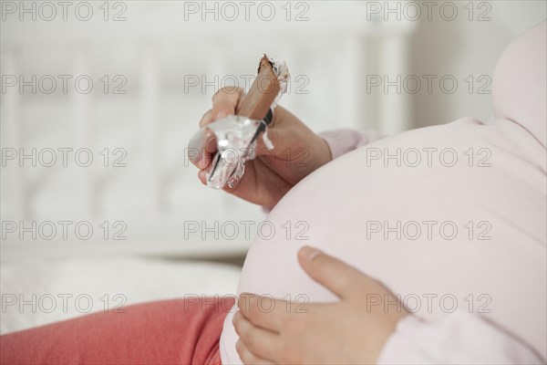 Pregnant woman eats chocolate