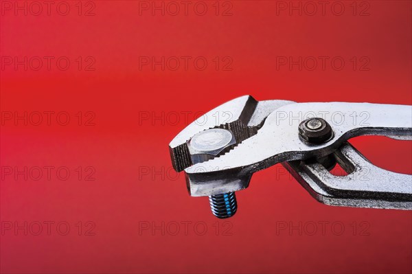 Water pump or gas pliers clamped onto a bolt