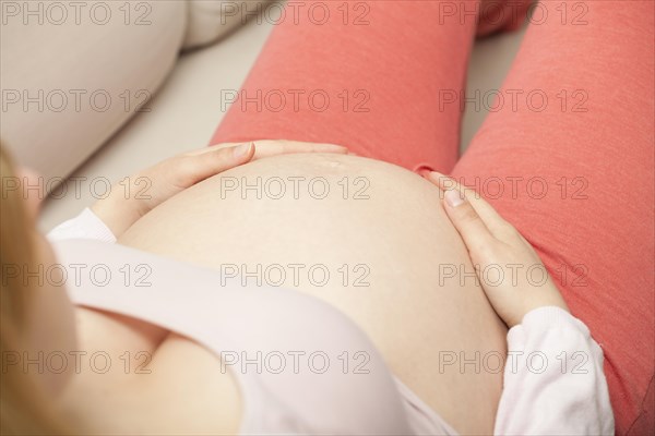 Pregnant woman has hands on baby belly | MR:yes nh_eyes_pregnant_mr