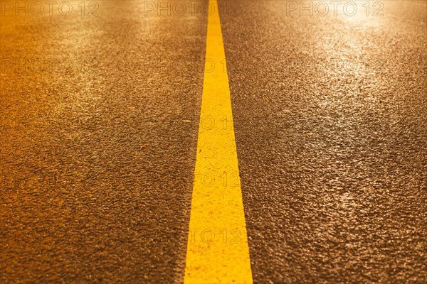 Yellow road marking in rain and at night