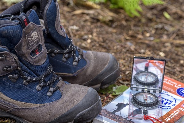 Pair of walking boots with a map and compass