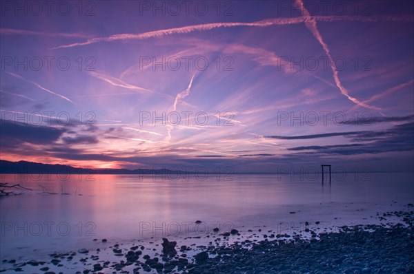 Sunset sky with condensation trails