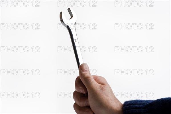 Man holding a chrome plated spanner