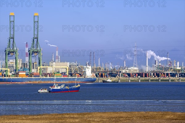 Harbor cranes and container ship docked in the Antwerp harbour