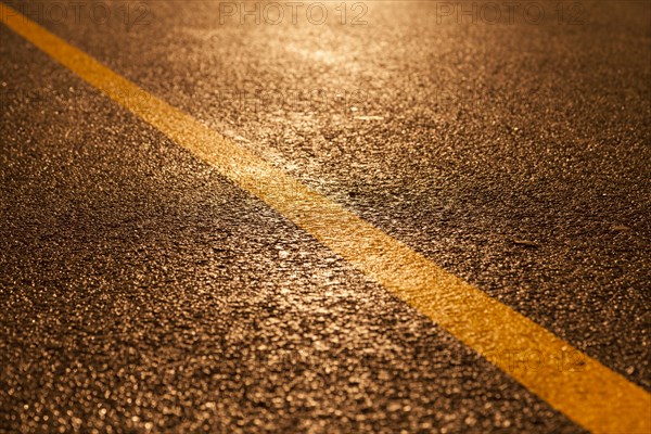 Yellow road marking in rain and at night