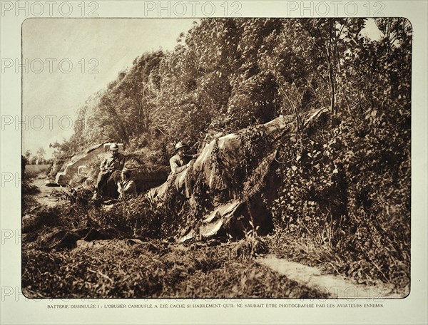 Soldiers hiding cannons with camouflage screens near the battlefield in Flanders during the First World War