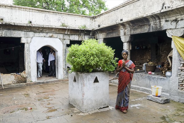 A woman worshipping rounding Tulsi