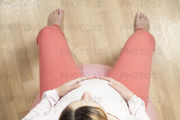 Pregnant woman sitting on an exercise ball