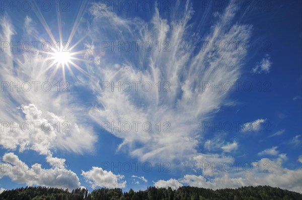 Backlight shot with sun star in the sky above the Allgaeu