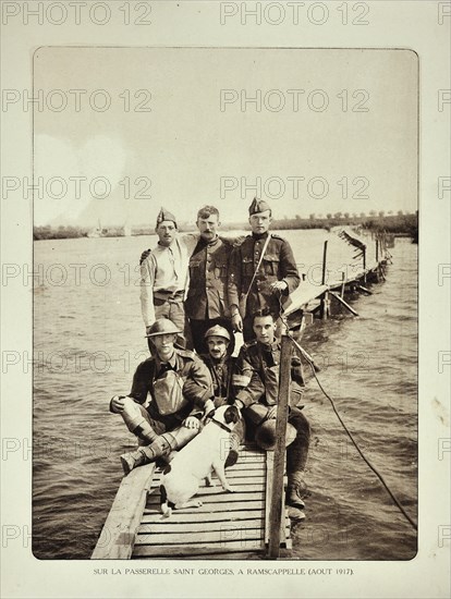 Soldiers with dog on boardwalk in flooded terrain at Ramskapelle in Flanders during the First World War