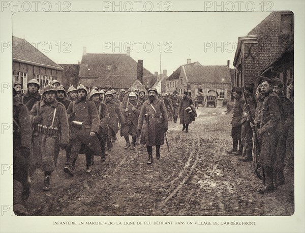 Infantry soldiers marching through village and heading for the battlefield in Flanders during the First World War