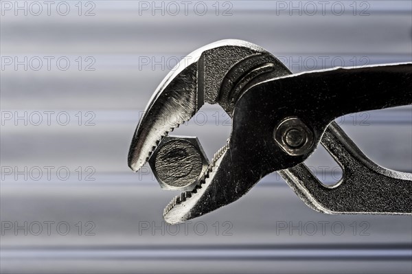 Water pump or gas pliers clamped onto a bolt