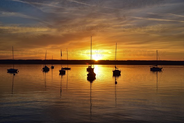 Sailing boats in the sunset in Herrschinger Bucht on Lake Lake Ammer