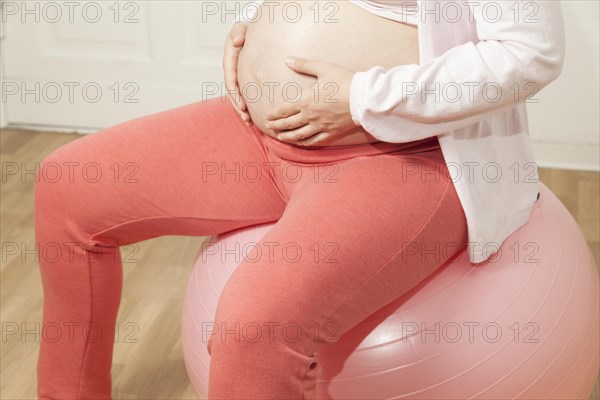 Pregnant woman sitting on an exercise ball