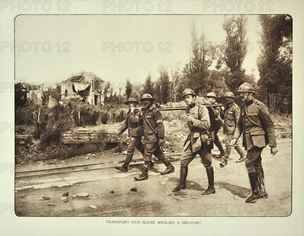 Transport of wounded English soldier on stretcher at Nieuwpoort in Flanders during the First World War