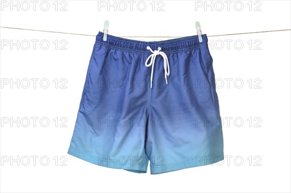Swim shorts hanging on a washing line