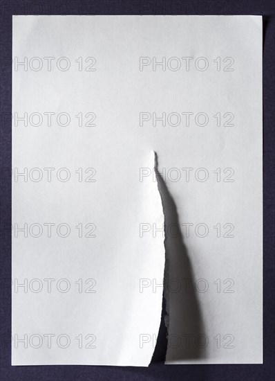 White sheet of paper with a tear