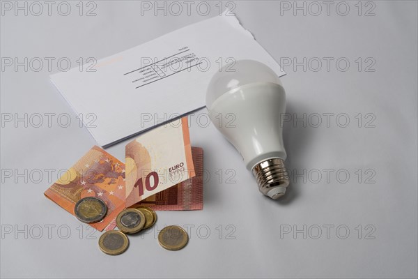 Light bulb and money energy saving concept