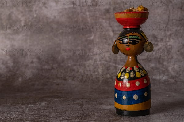 Hand-painted terracotta figure of a traditional handmade woman in close-up isolated close-up