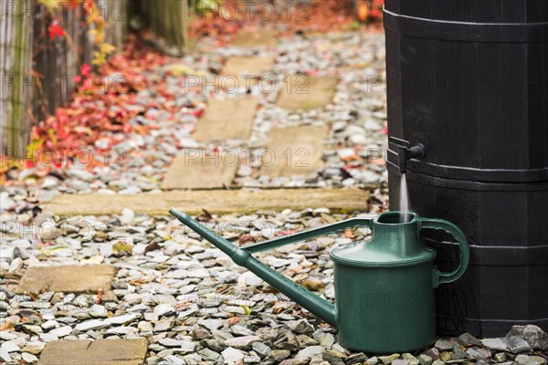 Water butt and green watering can