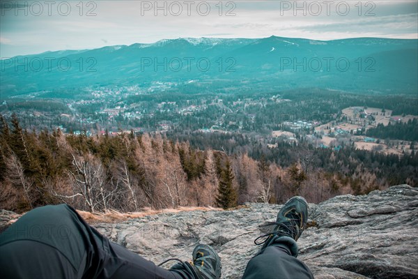 Hiker on a mountain trail overlooking the mountains