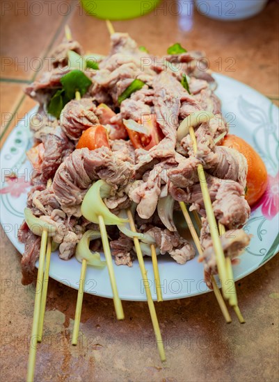 Raw beef skewers on a plate