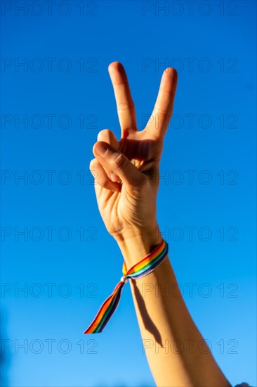 Hand of a woman with victory symbol in favor of feminism