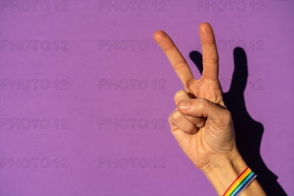 Hand of a woman with victory symbol in favor of feminism