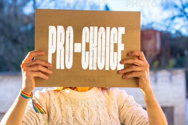 A woman holding a poster in her hands in favor of the legalization of abortion