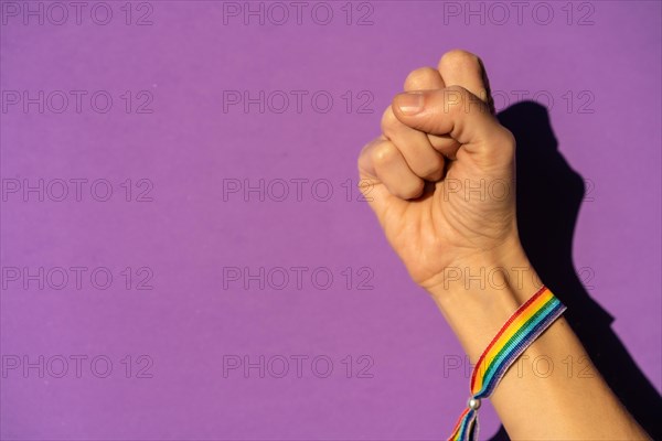 Hand of a woman with fist closed hard on fight symbol in favor of feminism